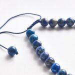 Sodalite handmade cat dog necklace, close-up of blue stone texture.